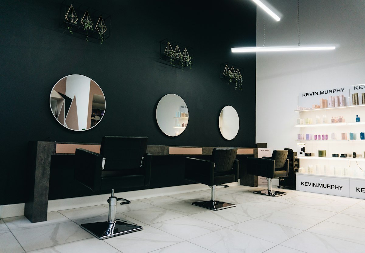 Salon chairs facing circular mirrors