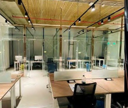 Glass meeting pods in a compact Riyadh office