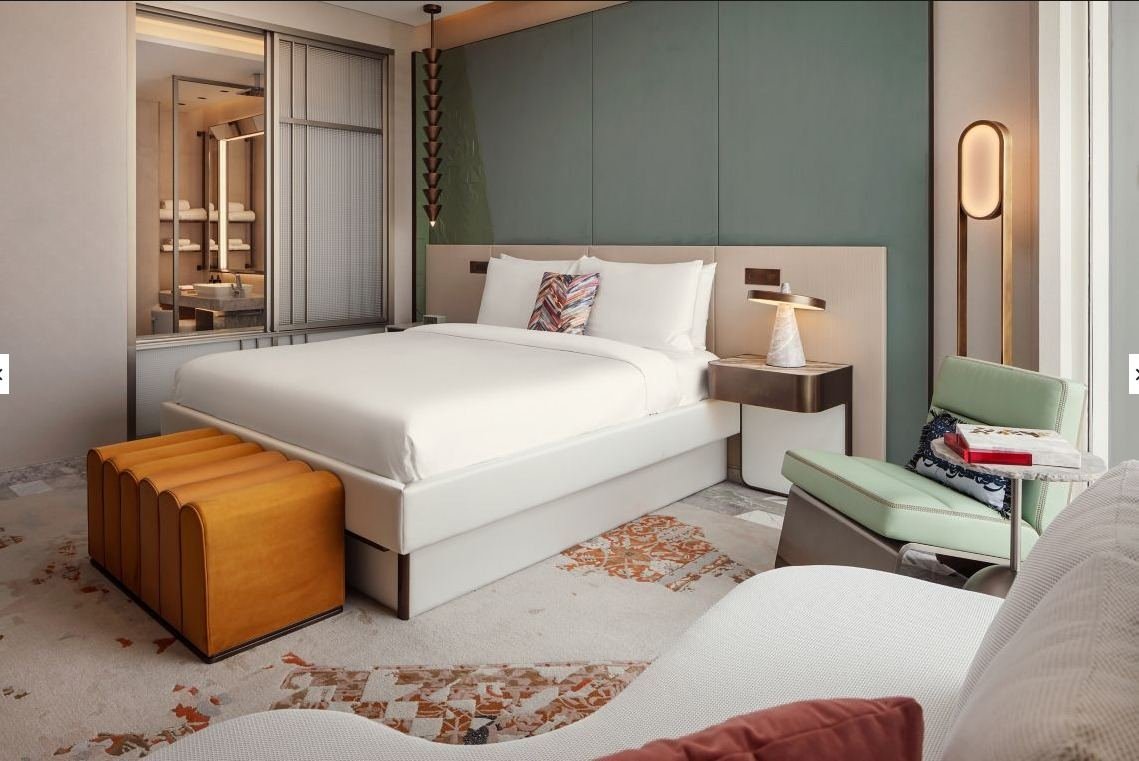 W Hotel KAFD guest room design intent — bedroom with glass-fronted bathroom